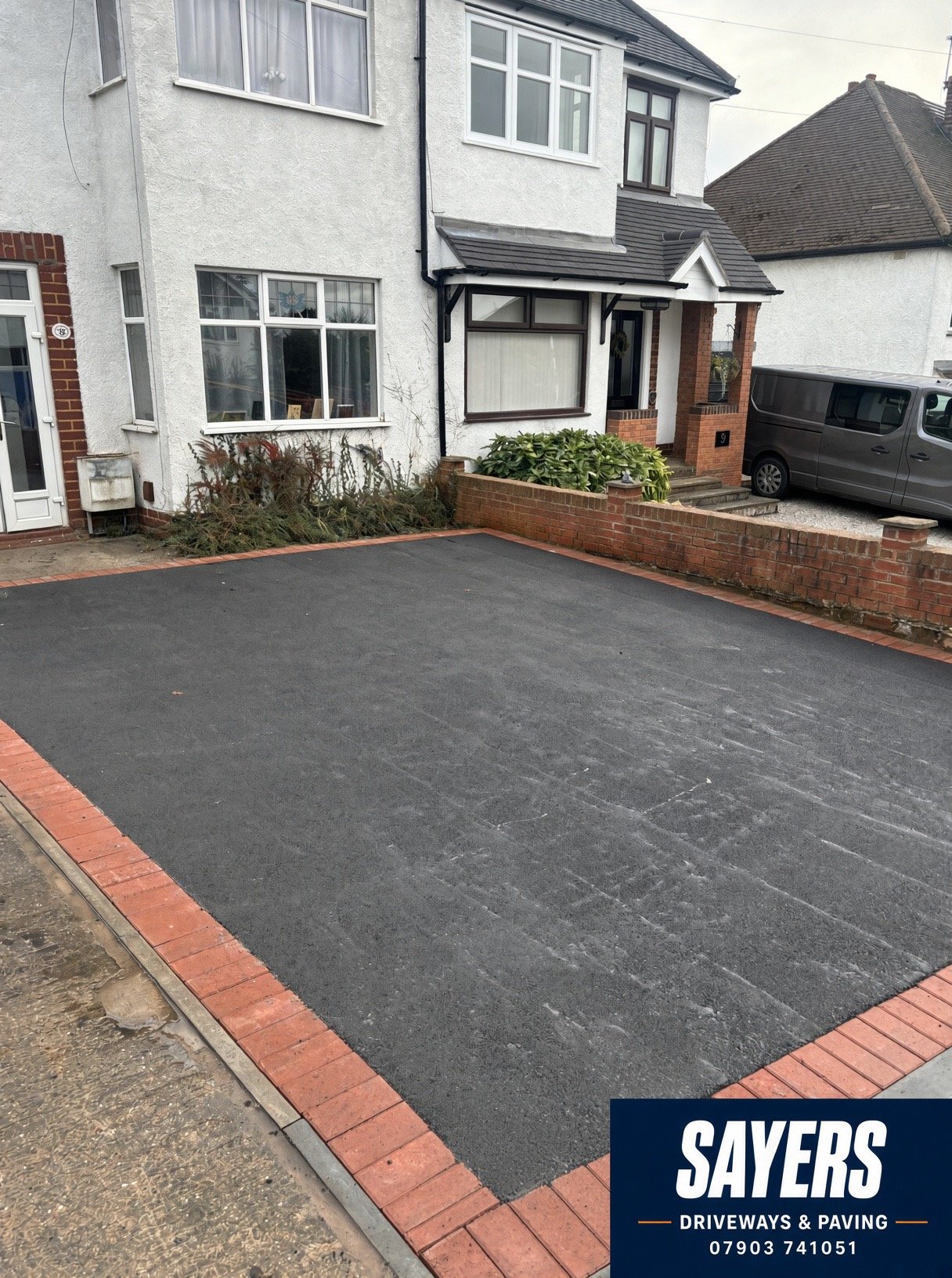 Completed tarmac driveway with red brick block paving border